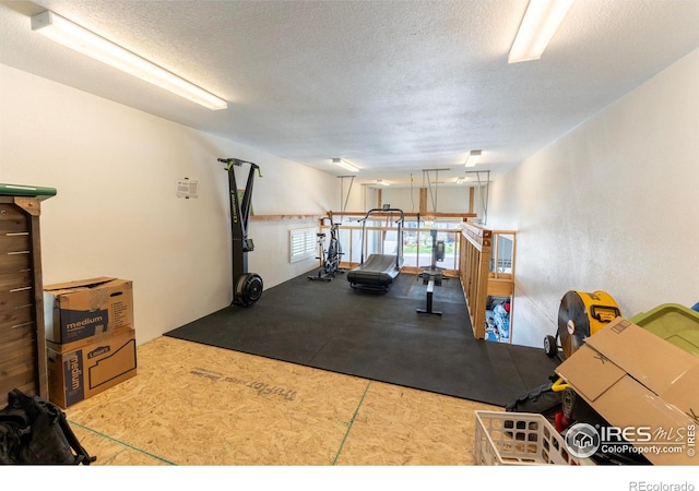 workout area with a textured ceiling