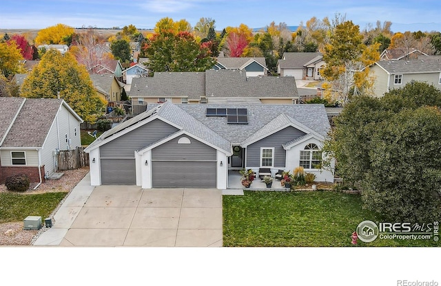 front facade with a front yard and a garage