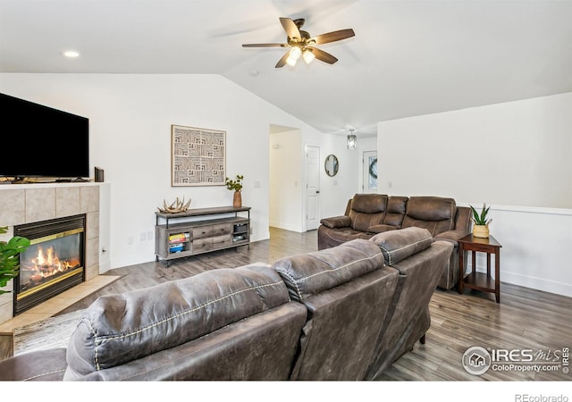 living room featuring hardwood / wood-style floors, vaulted ceiling, a fireplace, and ceiling fan