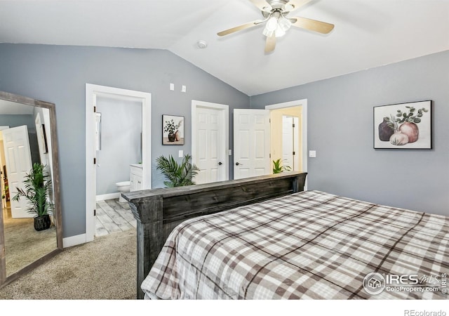 bedroom featuring ensuite bathroom, light carpet, lofted ceiling, and ceiling fan