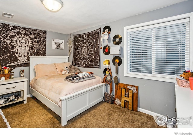 bedroom featuring dark carpet