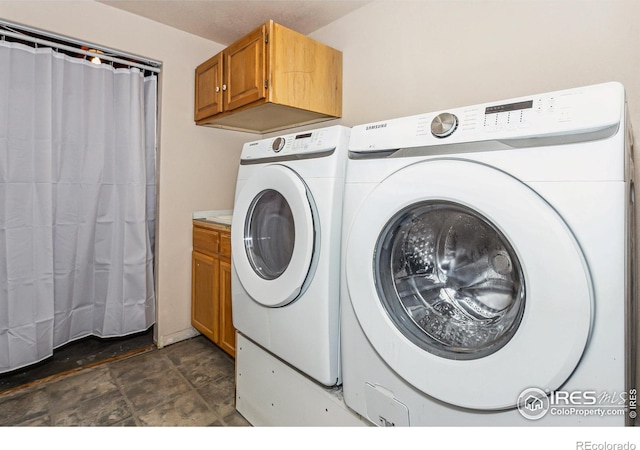 clothes washing area with washing machine and clothes dryer