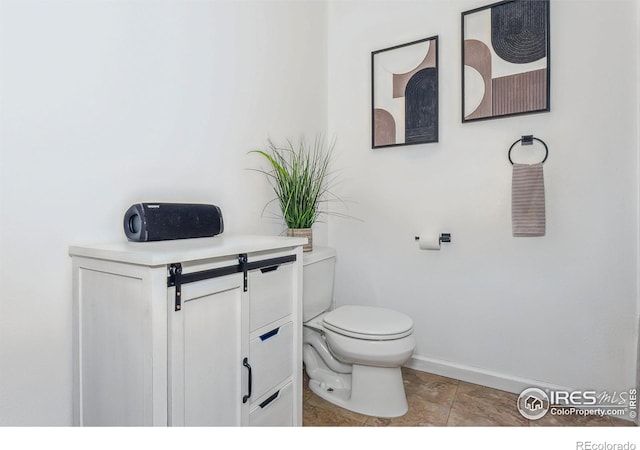 bathroom featuring vanity, toilet, and tile patterned flooring