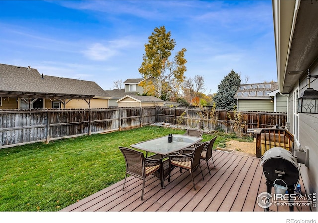 wooden terrace with a lawn