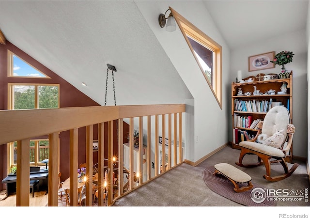 sitting room with lofted ceiling and carpet floors