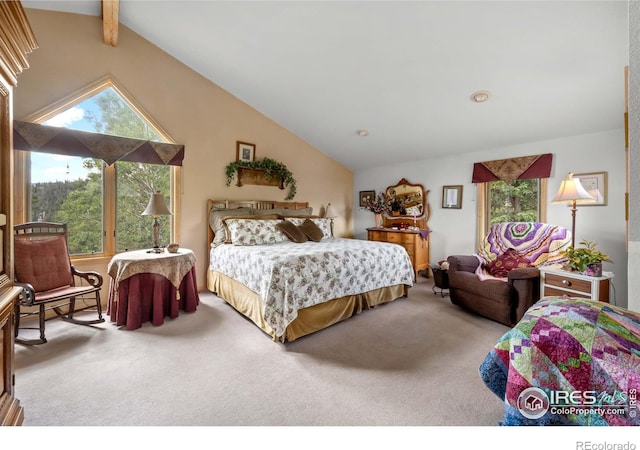 carpeted bedroom featuring beamed ceiling and high vaulted ceiling