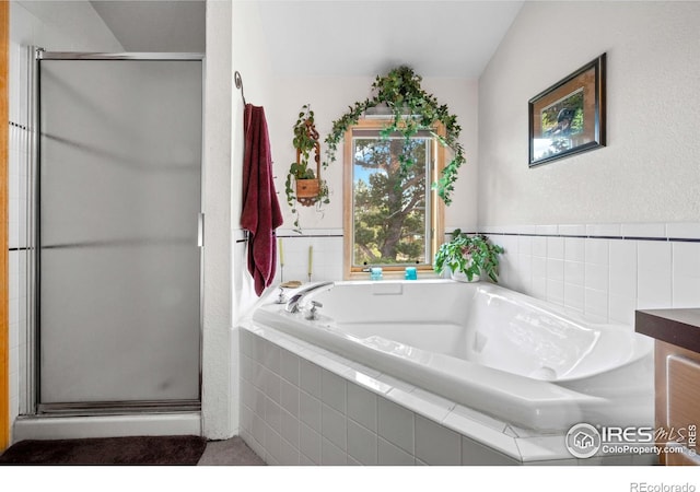 bathroom with vanity and independent shower and bath