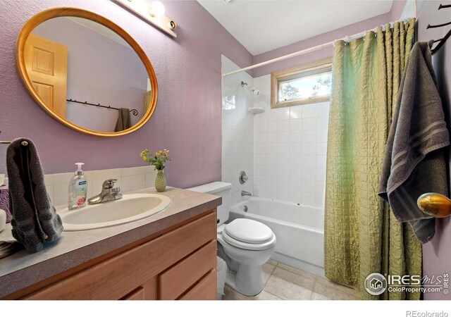 full bathroom with vanity, shower / tub combo with curtain, and toilet