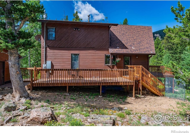 back of property featuring a wooden deck