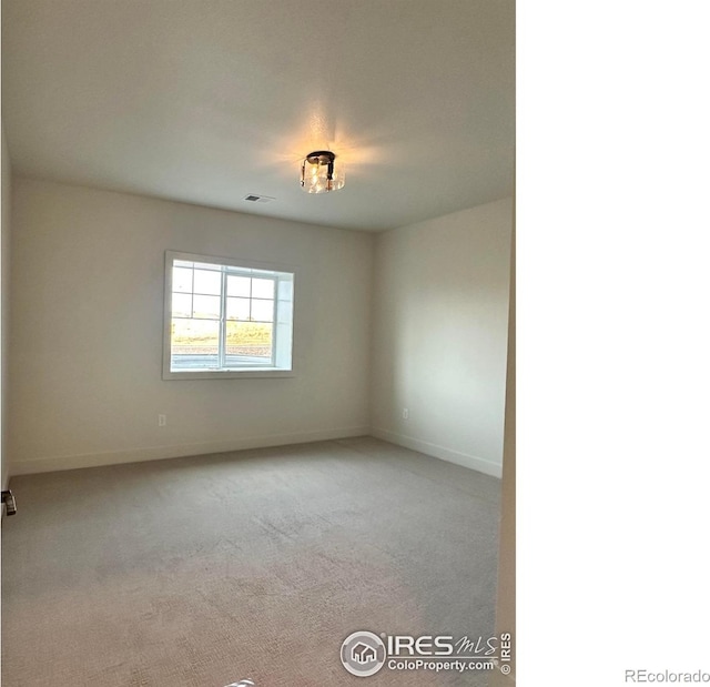 empty room featuring light colored carpet