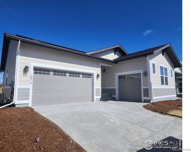 ranch-style home featuring an attached garage and driveway