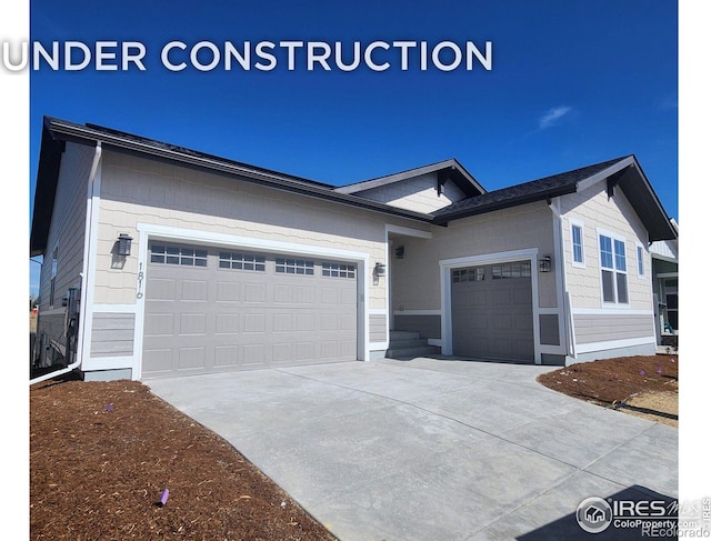 ranch-style home featuring an attached garage and driveway