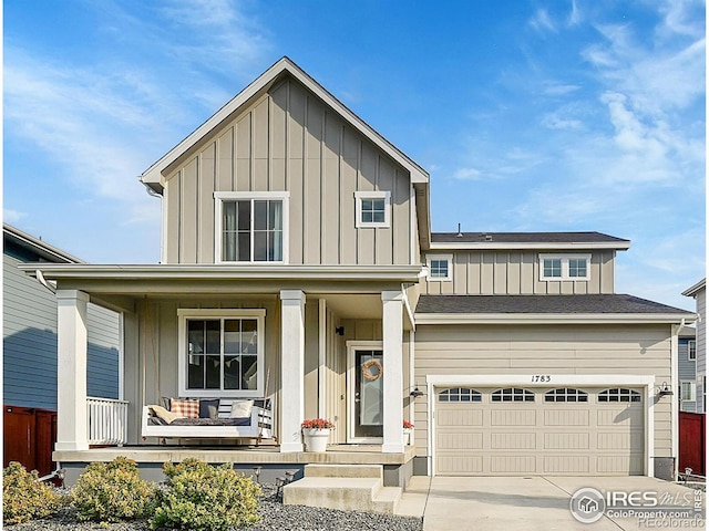 view of front of home with covered porch and a garage