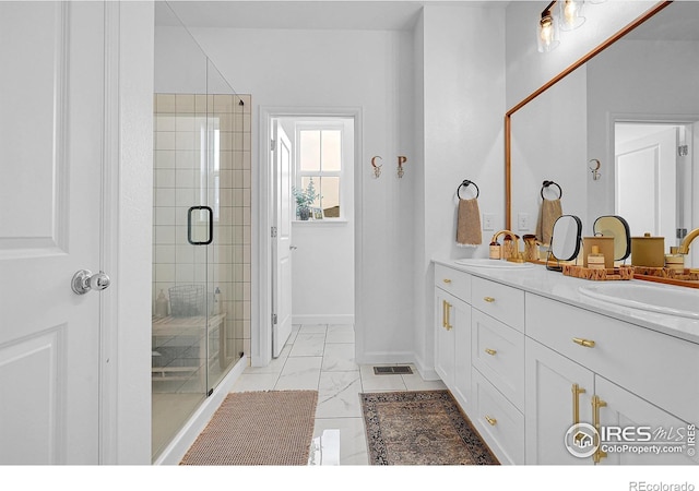 bathroom featuring vanity and an enclosed shower