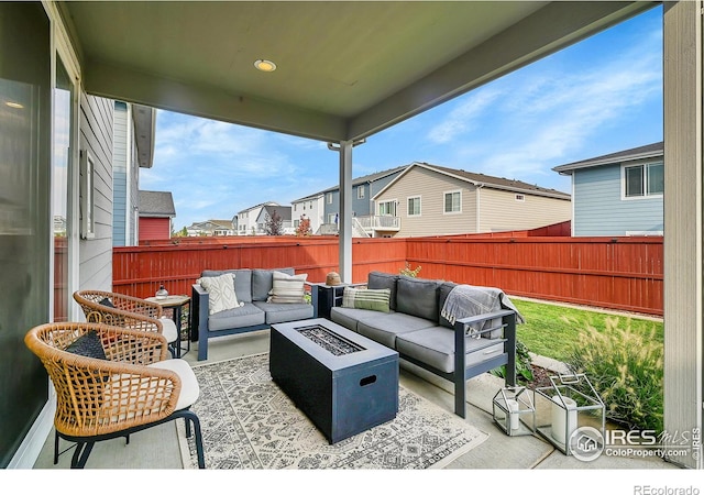 view of patio featuring an outdoor living space with a fire pit