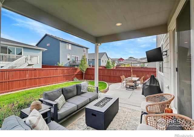 view of patio / terrace with an outdoor living space with a fire pit