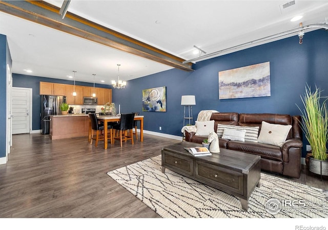 living room with beamed ceiling, a notable chandelier, and dark hardwood / wood-style flooring