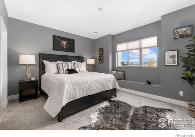 bedroom with light colored carpet