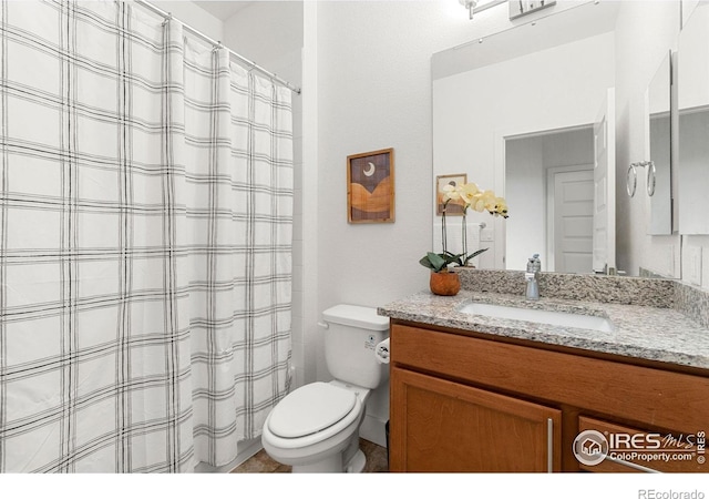 bathroom featuring vanity, toilet, and a shower with shower curtain