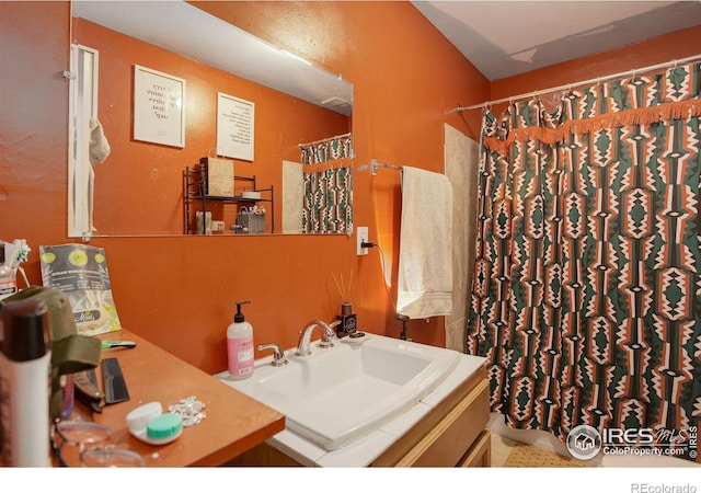 bathroom featuring vanity and a shower with shower curtain