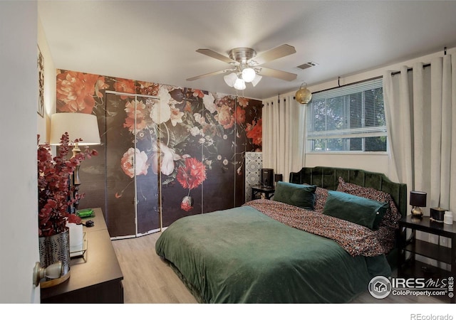 bedroom with ceiling fan and light hardwood / wood-style flooring