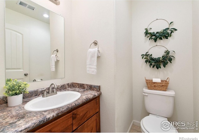 bathroom with toilet and vanity