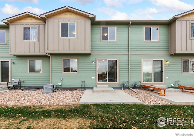 rear view of property featuring central air condition unit and a patio area