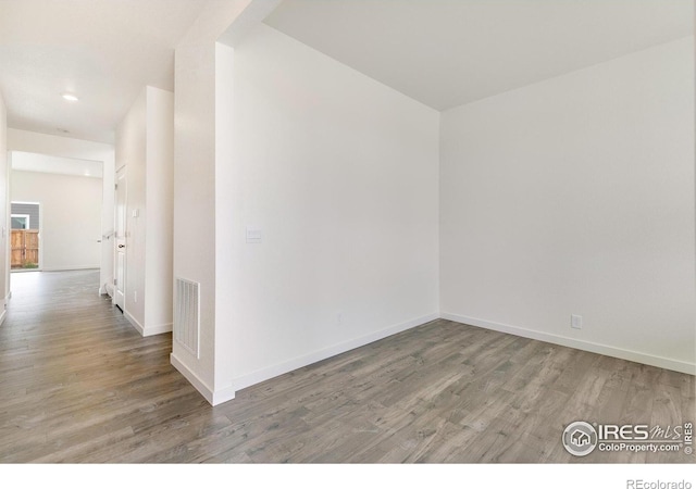 unfurnished room featuring hardwood / wood-style flooring