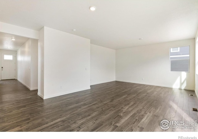 spare room with dark hardwood / wood-style floors