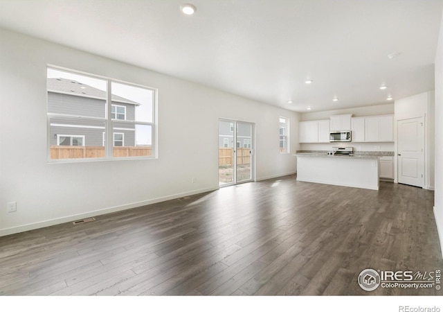 unfurnished living room featuring dark wood-type flooring