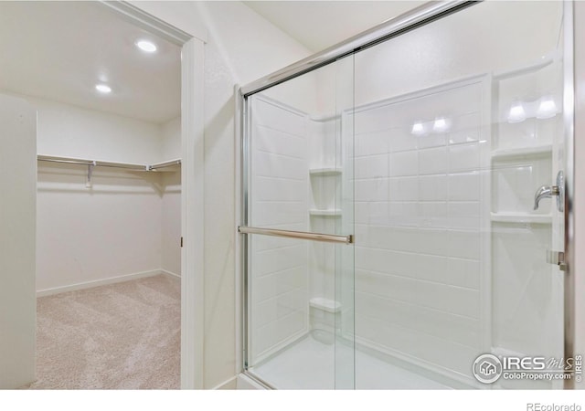 bathroom with a shower with door