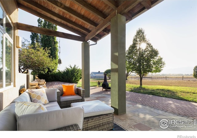 view of patio / terrace featuring an outdoor living space and a rural view