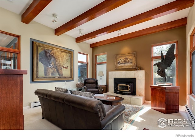 carpeted living room with a wealth of natural light, beam ceiling, a baseboard heating unit, and a tile fireplace