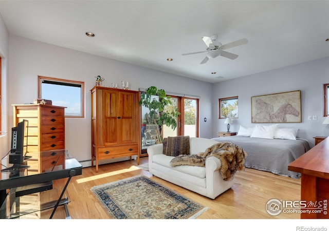 bedroom featuring a baseboard radiator, ceiling fan, and light hardwood / wood-style flooring