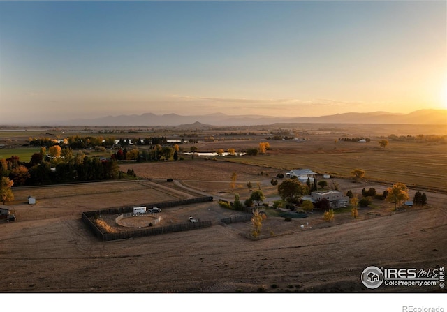 aerial view at dusk featuring a mountain view