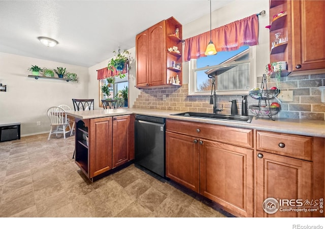 kitchen with stainless steel dishwasher, hanging light fixtures, a healthy amount of sunlight, and kitchen peninsula