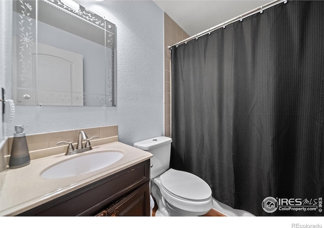 bathroom with vanity, toilet, and a shower with curtain