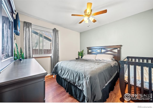 bedroom with hardwood / wood-style floors and ceiling fan