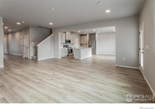 unfurnished living room with light hardwood / wood-style floors