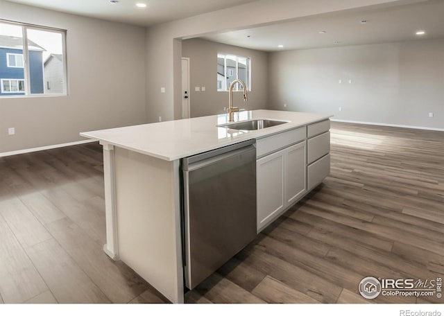 kitchen featuring white cabinetry, sink, stainless steel dishwasher, and a center island with sink