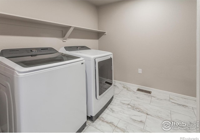 clothes washing area featuring independent washer and dryer