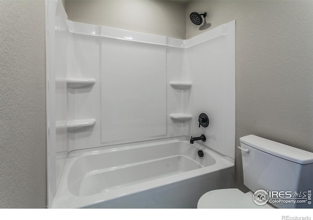 bathroom with shower / bath combination and toilet