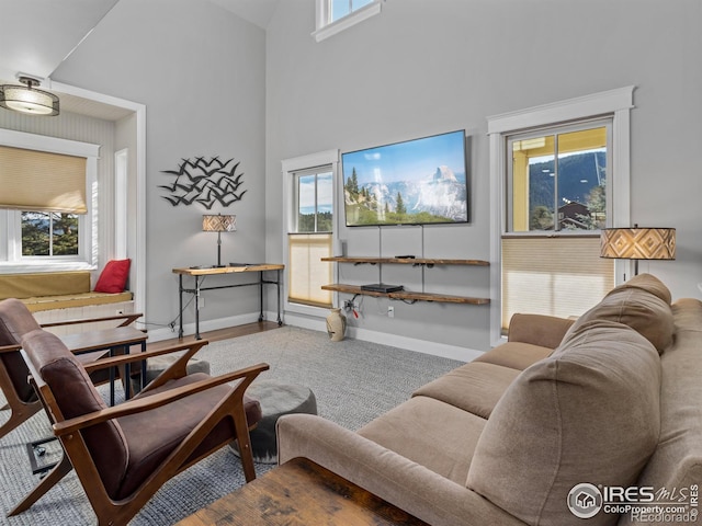 living room with high vaulted ceiling and plenty of natural light