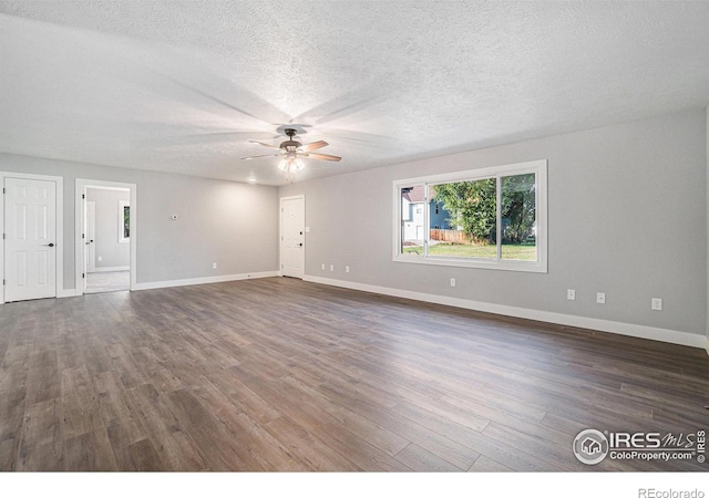 empty room with a textured ceiling, dark wood-type flooring, and ceiling fan