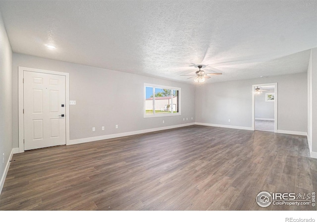 empty room featuring a textured ceiling, ceiling fan, and dark hardwood / wood-style flooring