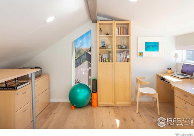 home office with lofted ceiling with beams and light hardwood / wood-style floors