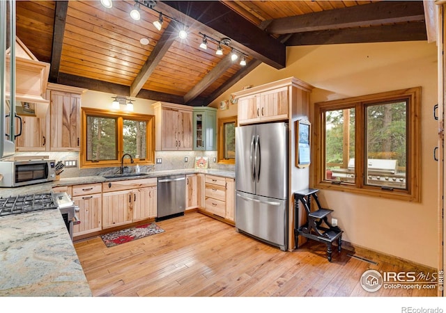 kitchen featuring lofted ceiling with beams, plenty of natural light, light brown cabinetry, appliances with stainless steel finishes, and light hardwood / wood-style floors