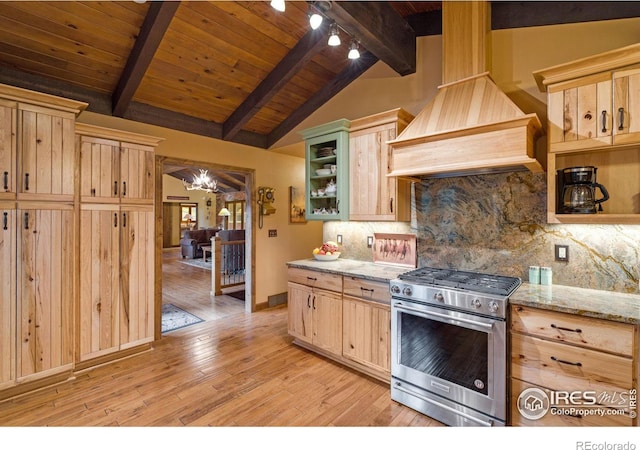 kitchen with stainless steel range, light brown cabinets, vaulted ceiling with beams, and light wood-type flooring