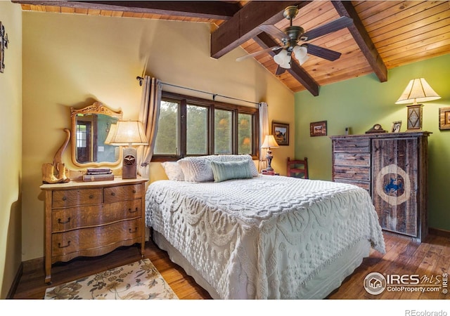 bedroom with hardwood / wood-style floors, vaulted ceiling with beams, and ceiling fan