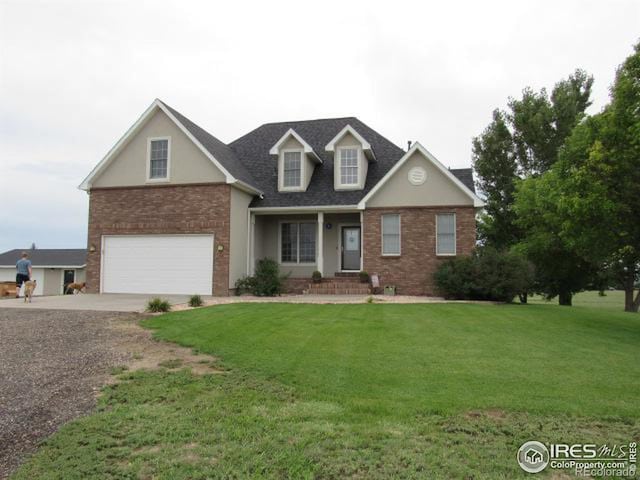 view of front of home with a front lawn and a garage